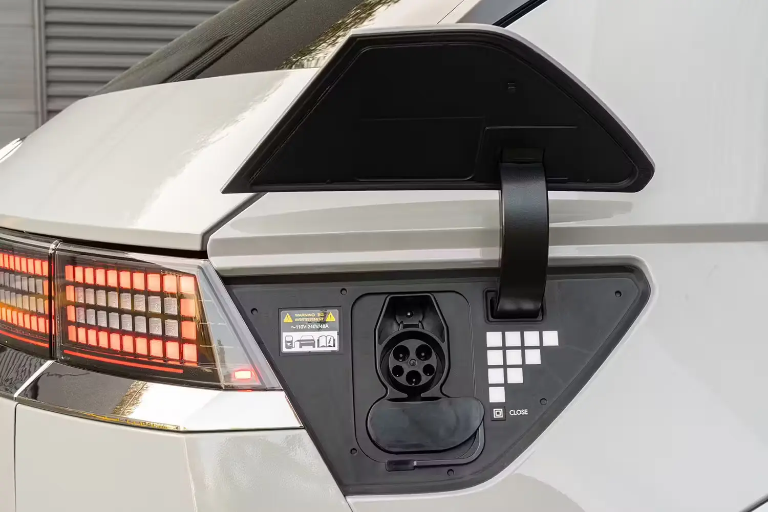 Electric vehicle driving through a scenic landscape